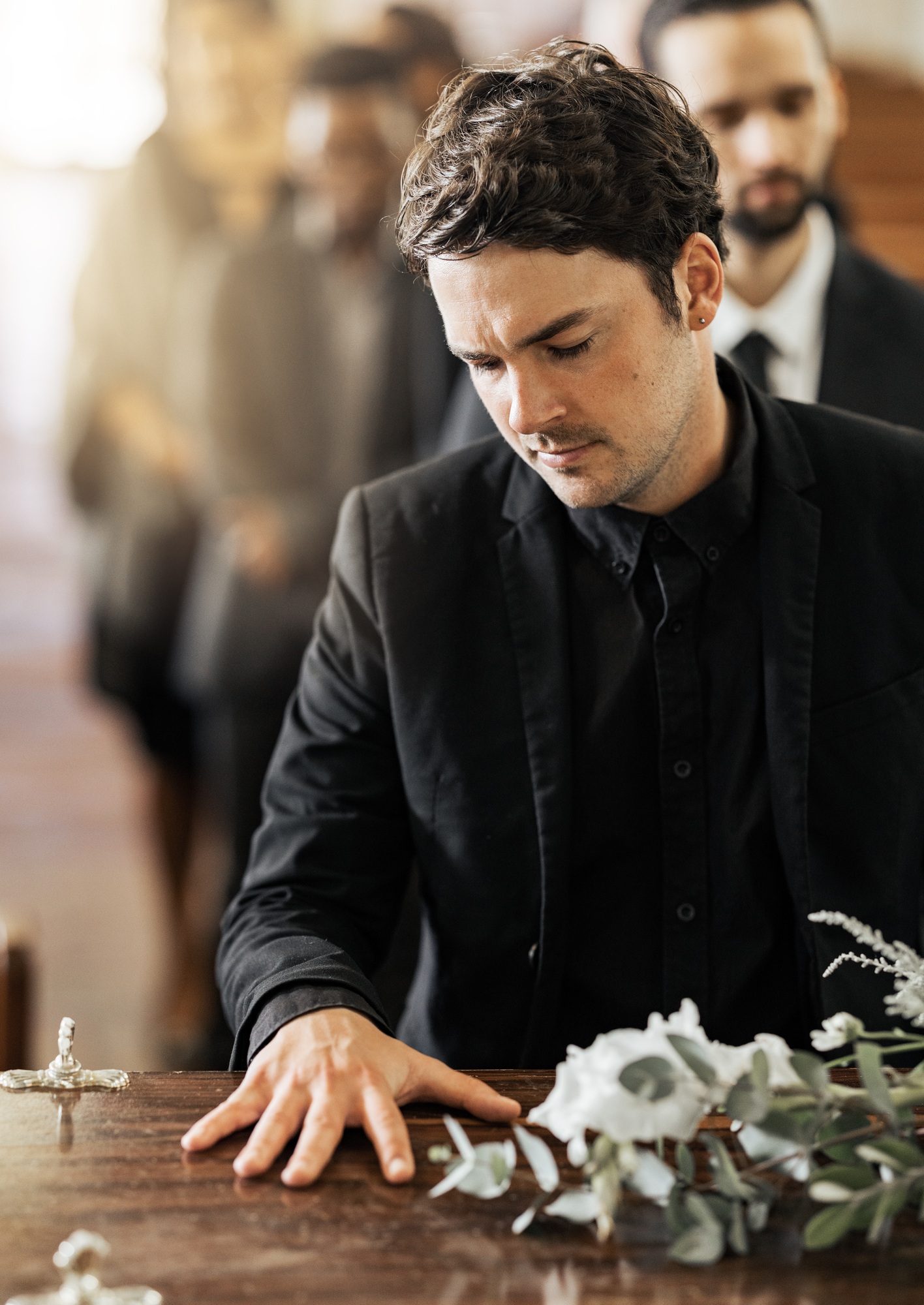 Sad, funeral and coffin with man in church for death, mourning and respect at burial ceremony. Flow